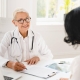 Allergist talking to a patient and writing on a clipboard