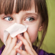 girl blowing nose