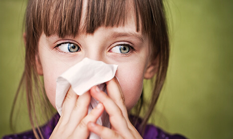 girl blowing nose