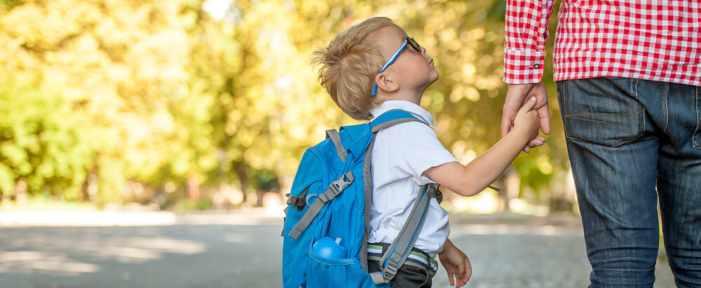 Child and father waiting for school bus