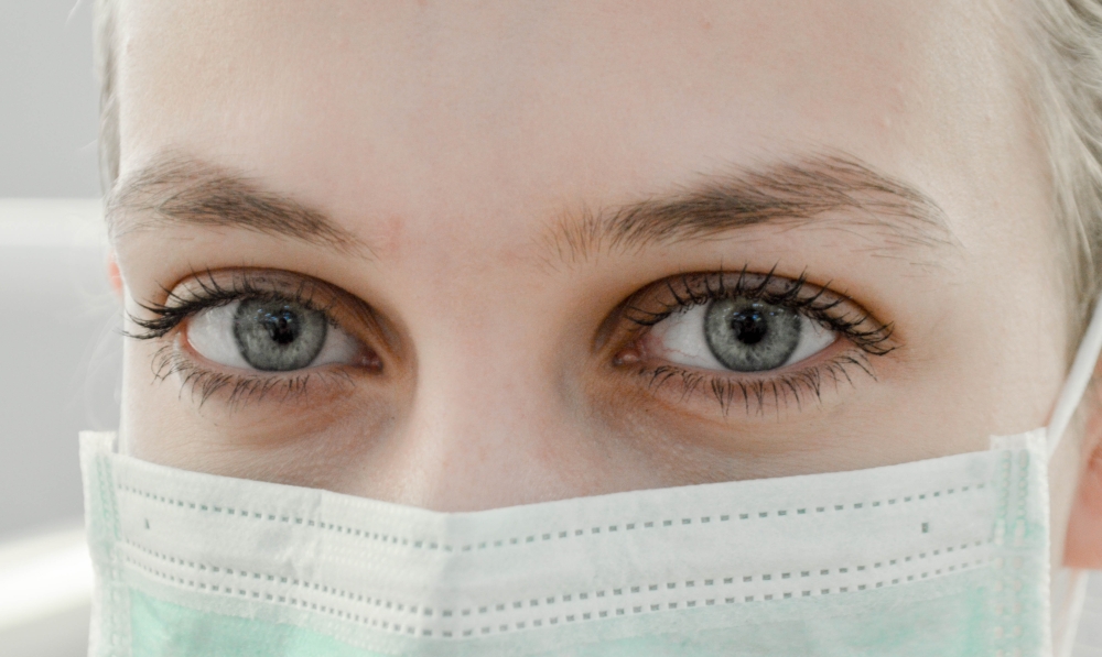 Close up of a women's face and eyes. She is wearing a mask.