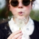 Woman blowing a dandelion.