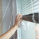 women putting down blinds